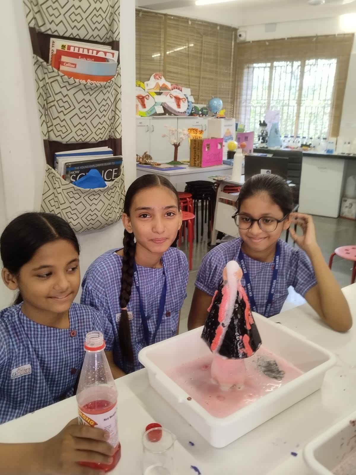 Students observing volcano models